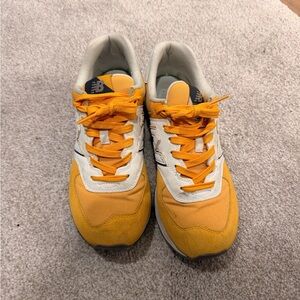 New Balance Women’s 574 split yellow and navy sneakers